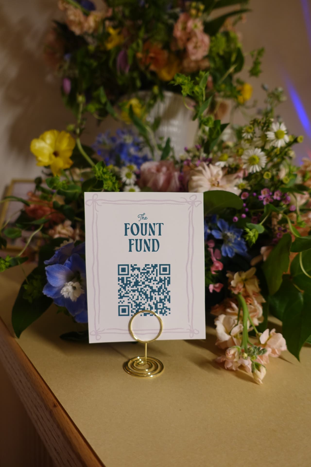 The Fount Fund sign surrounded by flowers at the launch party